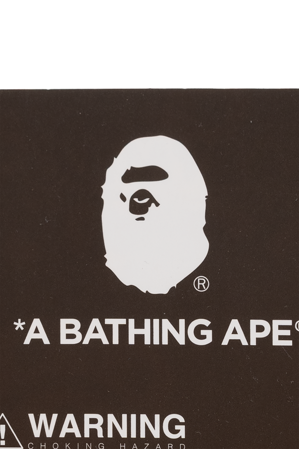 A BATHING APE® Keychain with a monkey motif