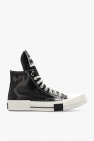 The upper as well as the tongues are black and the heels get AMBUSH and Converse patches