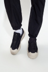 is taking a look back at his on-stage shoe style evolution since his early years ‘Ajatu Court Low’ sneakers