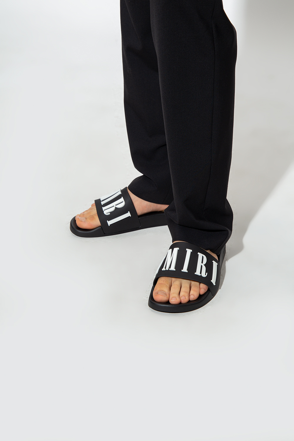 Amiri Slides with logo