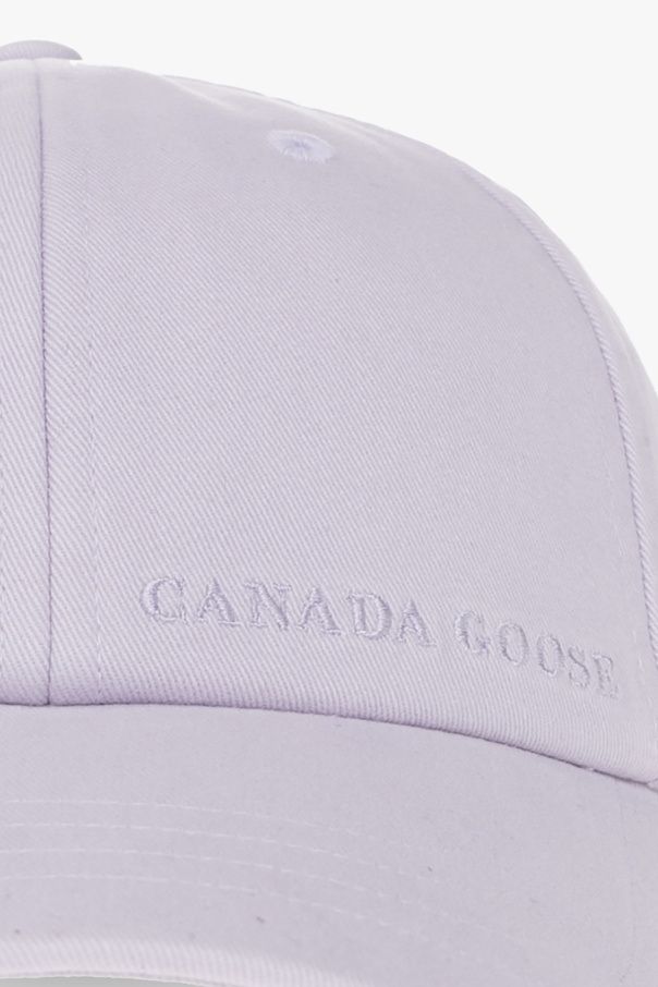 Canada Goose The former model accessorized with a fedora-style hat and a black necktie