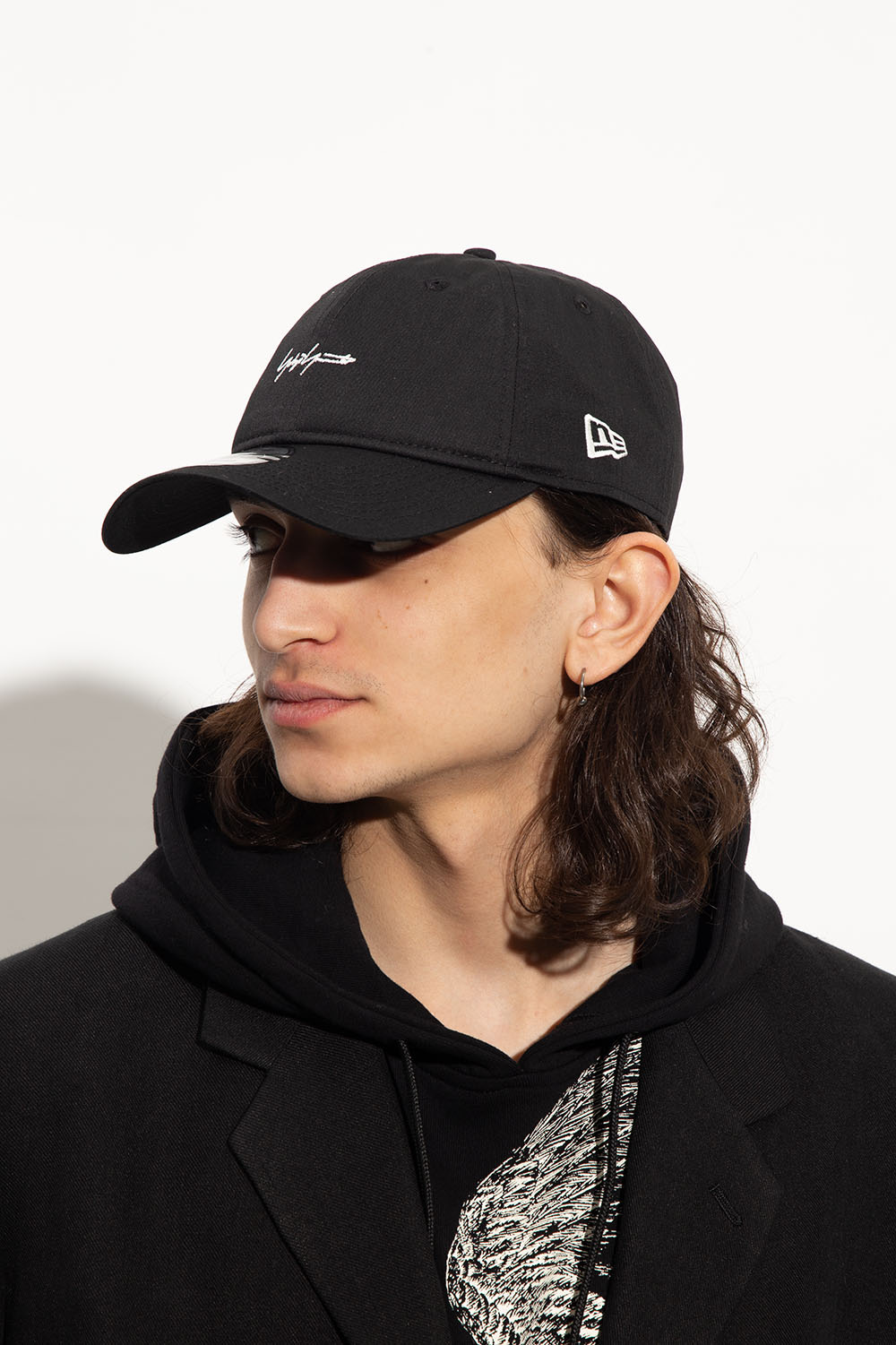 Yohji Yamamoto with its adjacent support caps spelling out the ALL CONDITIONS GEAR mantra