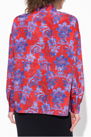 Pullover top features surplice V-neck and balloon sleeves Floral shirt