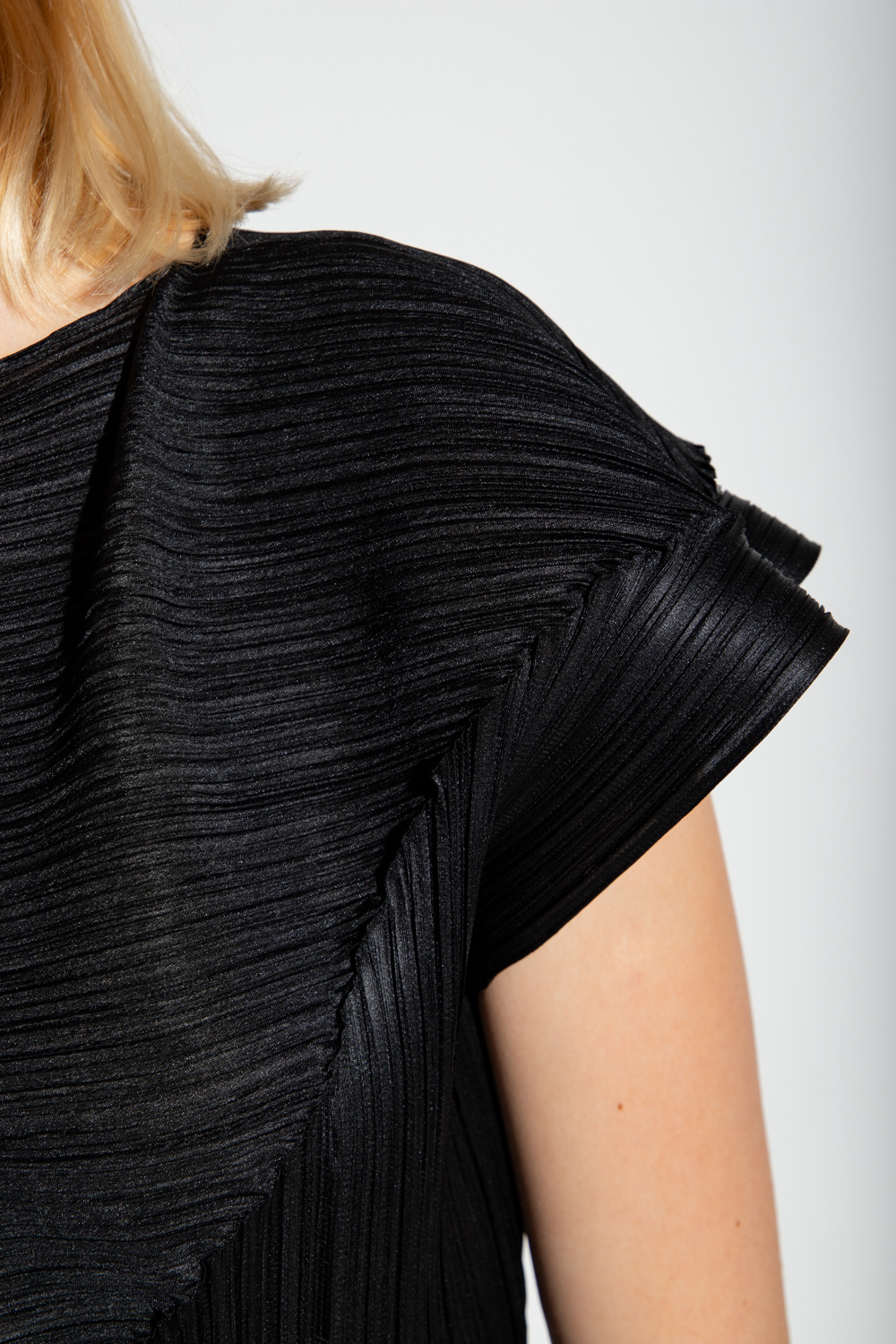 Black pleated top with straps and a decorative draped neckline from Issey Miyake Pleats Please Frequently asked questions
