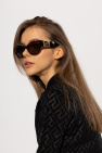 Versace The model completed her outfit with black Oliver Peoples sunglasses and a python-print bag