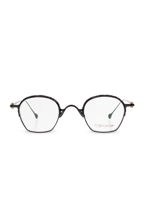 Glasses with a slim metal frame and rounded, slightly octagonal
profile