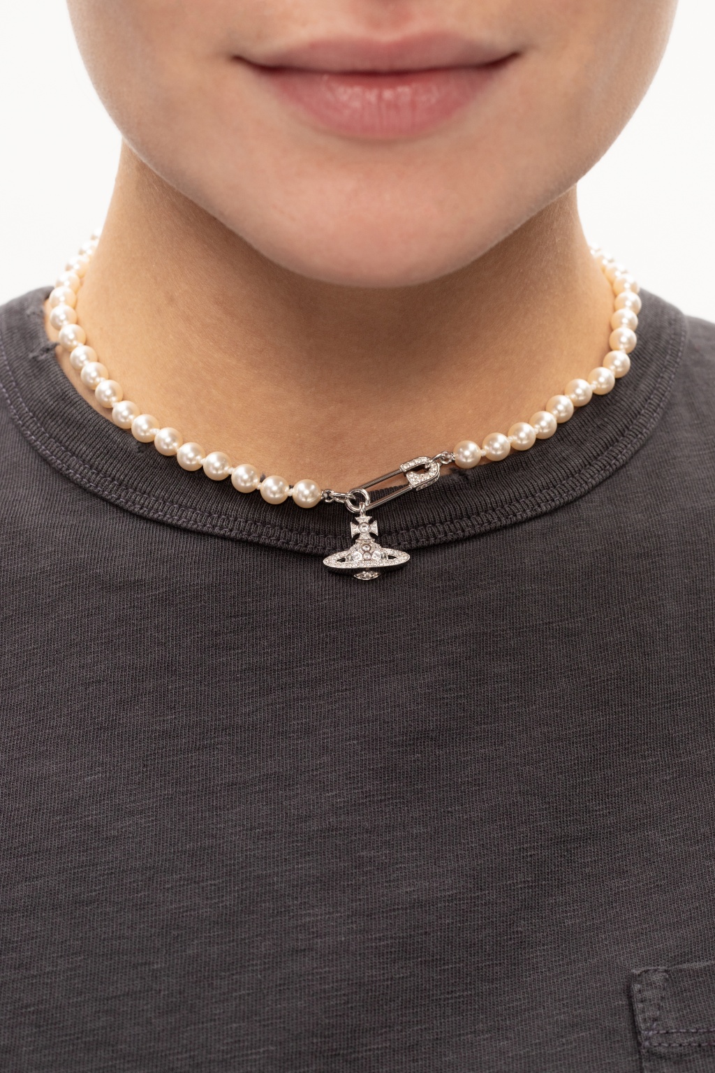 A guest wears pearls pendant necklaces from Vivienne Westwood, a