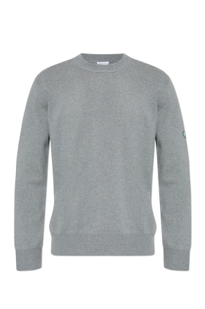 Sweater with a patch on the sleeve