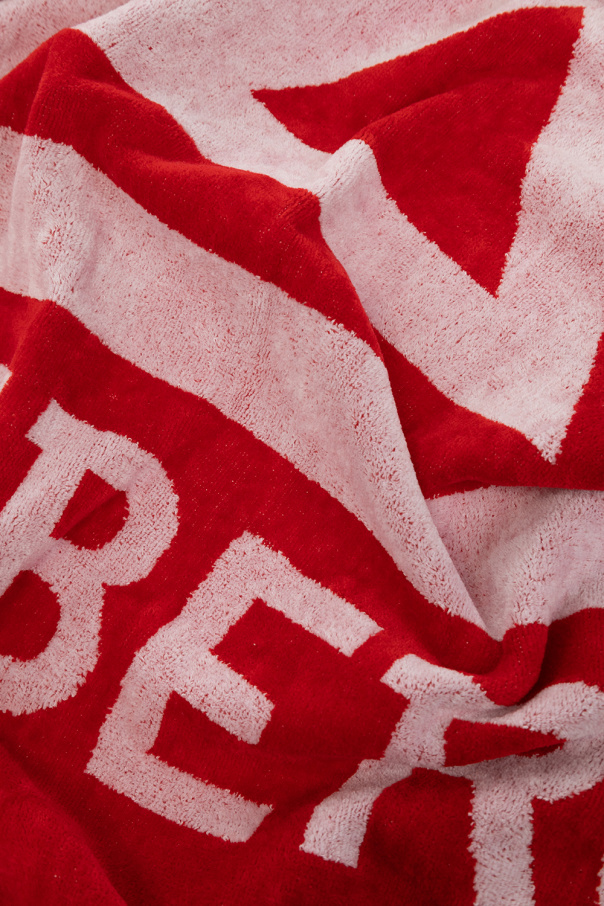 Iceberg Red towel from . Crafted from terry cotton, this item showcases a white logo for brand recognition