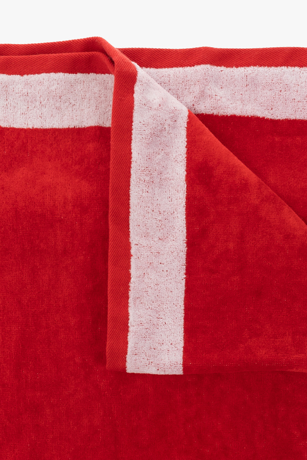 Iceberg Red towel from . Crafted from terry cotton, this item showcases a white logo for brand recognition