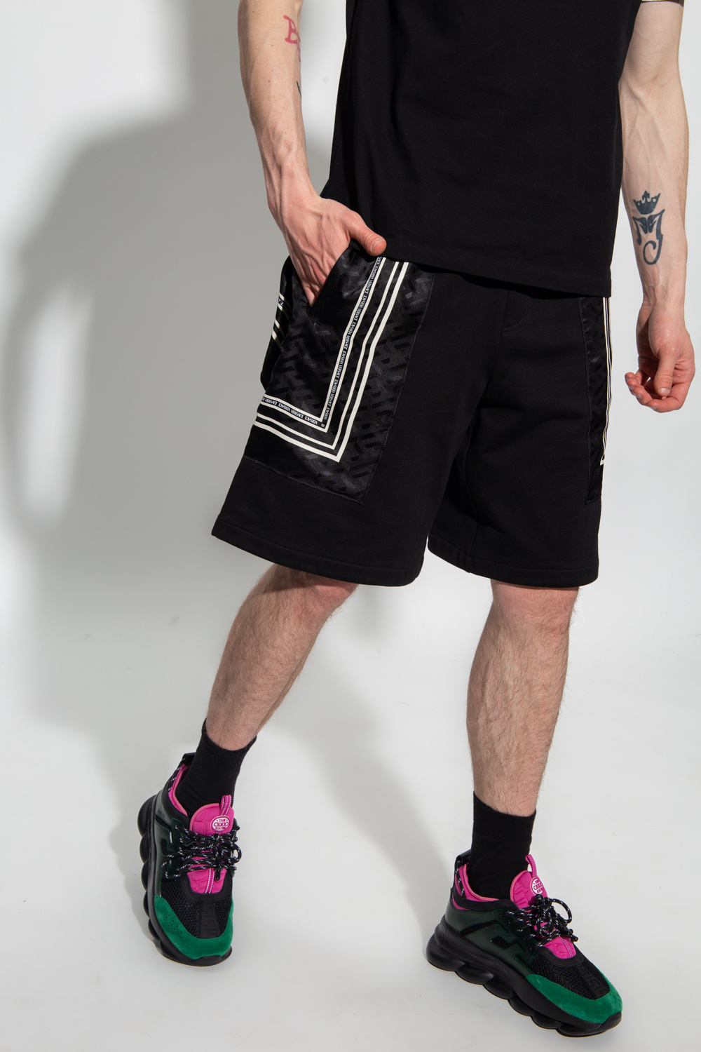 Versace Washed black cotton blend raw edge mini shorts from Andorine