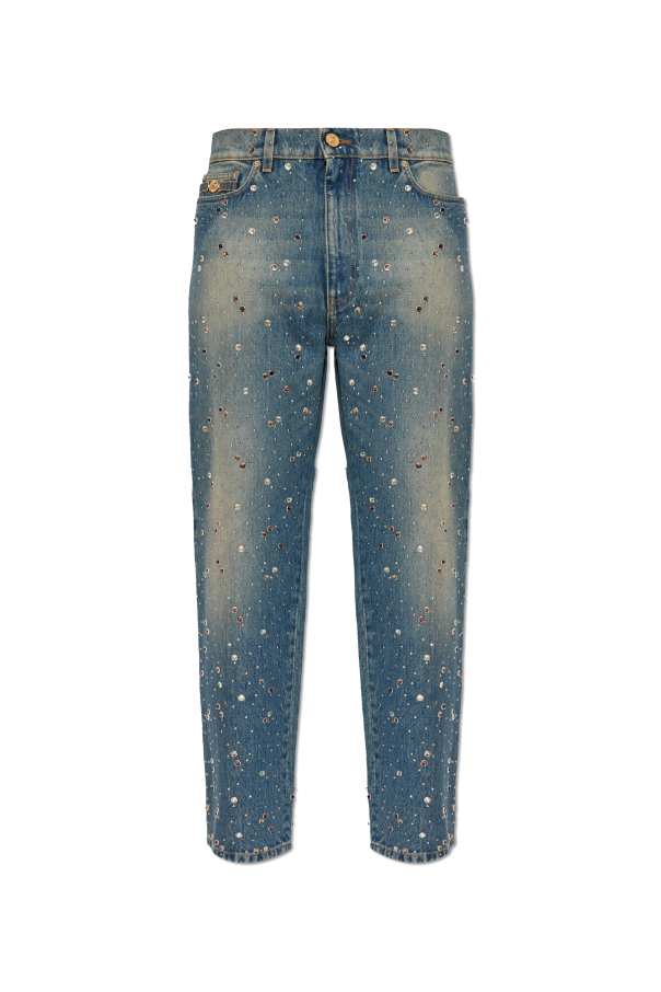 Jeans with shimmering appliqués od Versace
