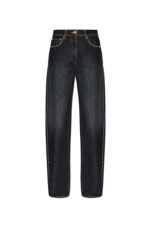 Jeans with shimmering appliqués od Versace