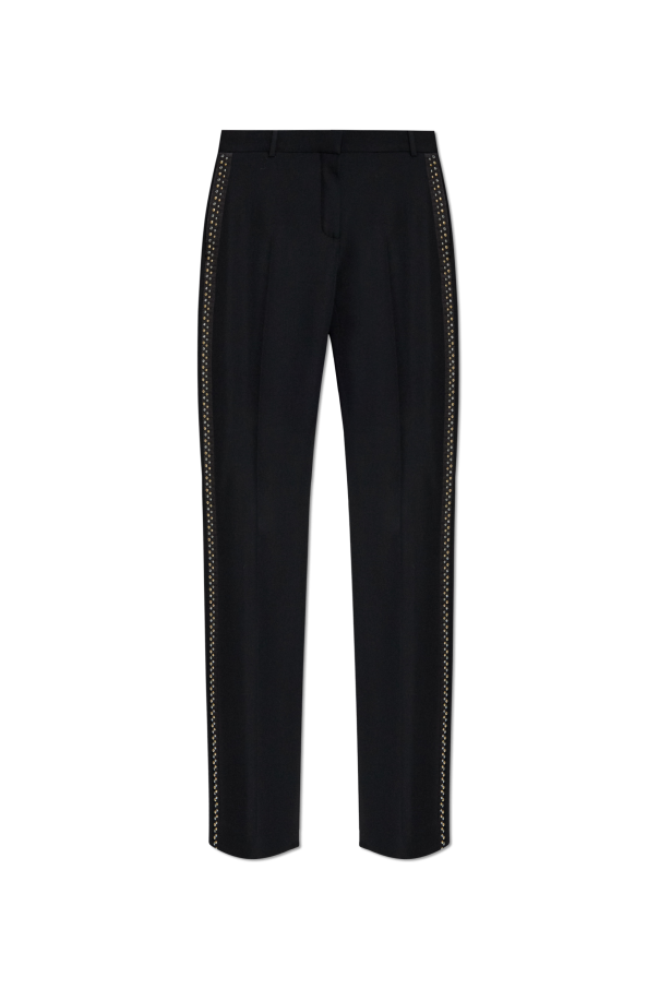 Creased trousers with studs od Versace