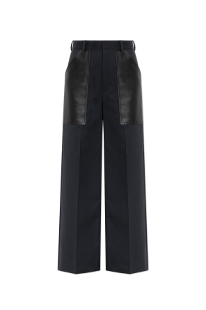 Trousers with leather pockets