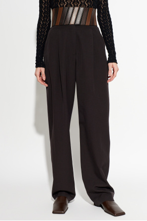 Alaïa Calças com detalhes em pele na cintura