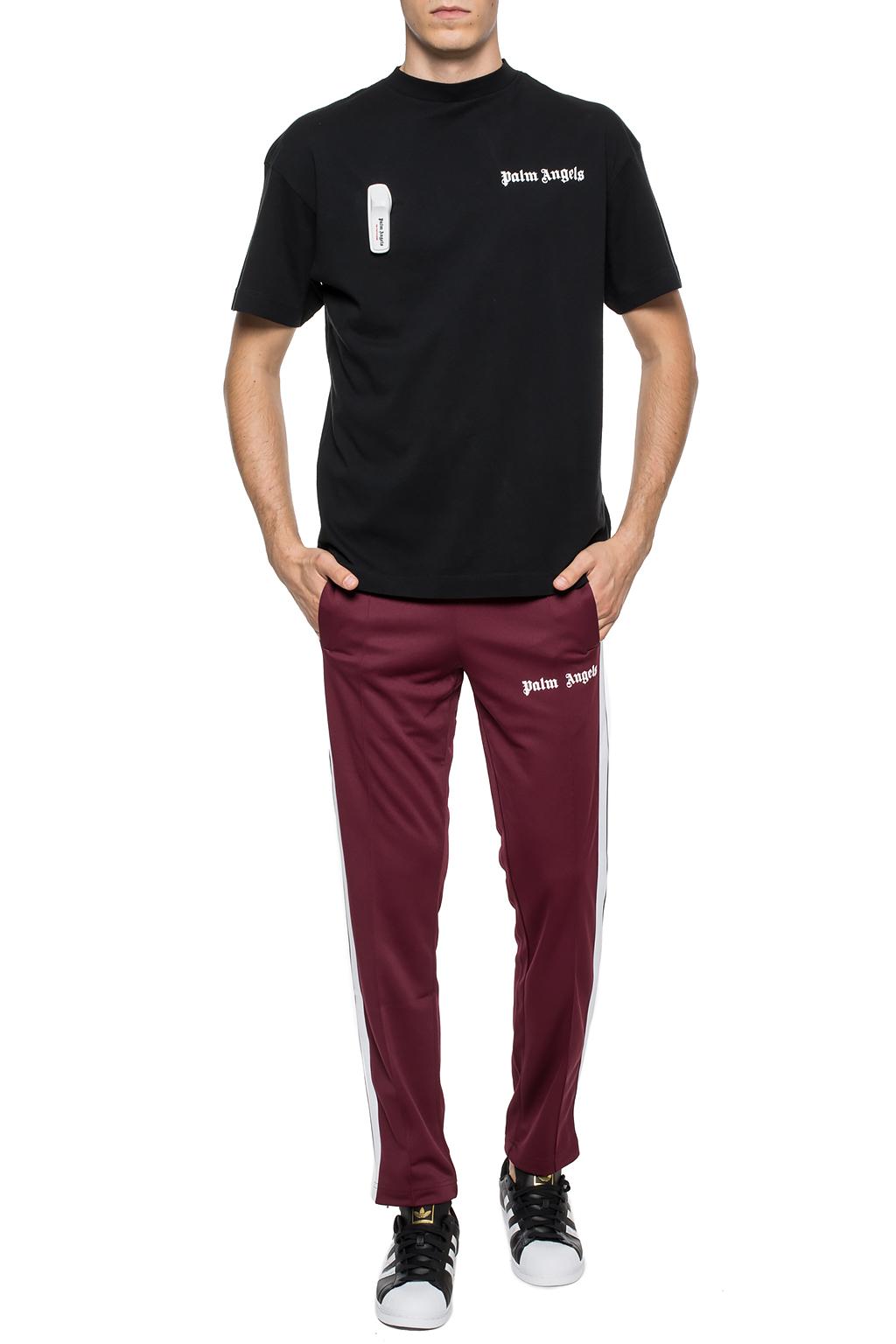 PALM ANGELS: jogging trousers with all over logo - Red