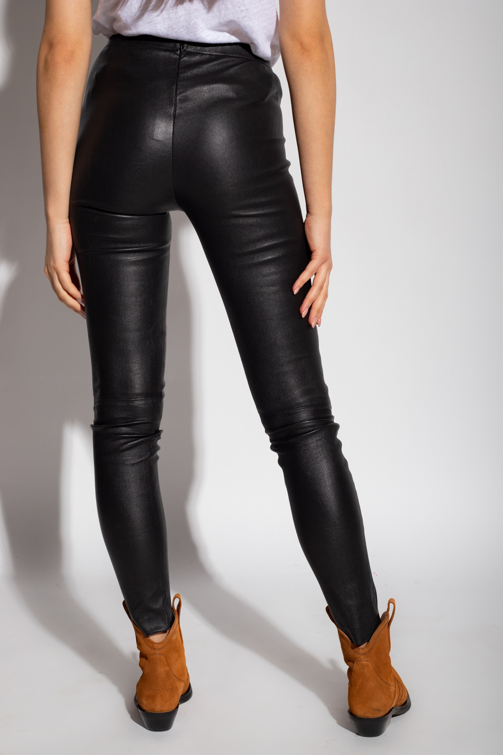 teamed a slick bodysuit with logo-coated pants and a buzzy set of sneakers Leather leggings