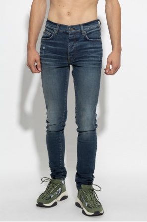 Amiri over denim jeans and sneakers