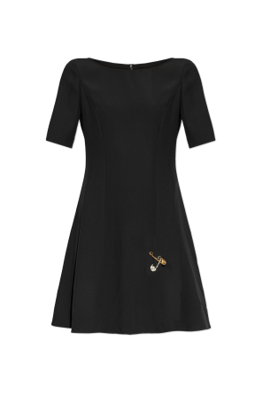 Dress with decorative safety pins