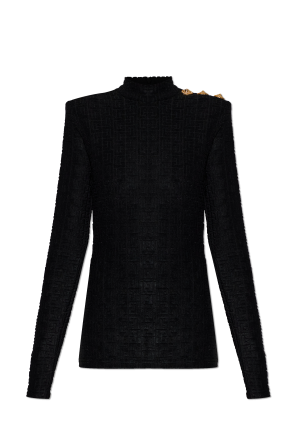 Top with decorative buttons on the shoulder