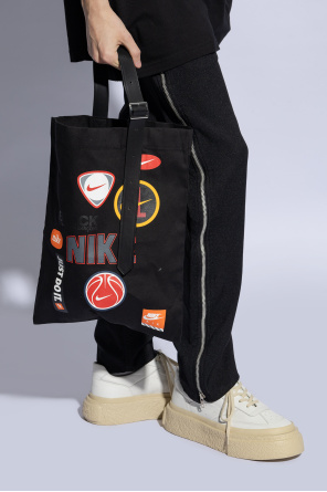 Comme des garcons black x nike od with a bold yellow sweater and her go-to Christian Louboutin So Kate pumps